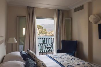 Zimmer mit Doppelbett und Balkon mit Blick auf Meer