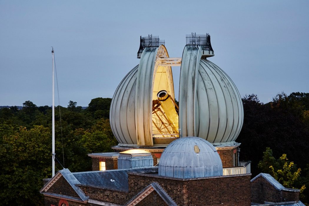Riesiges Teleskop was bei Nacht aus dem Dach des Royal Observatory in Greenwich, London ragt