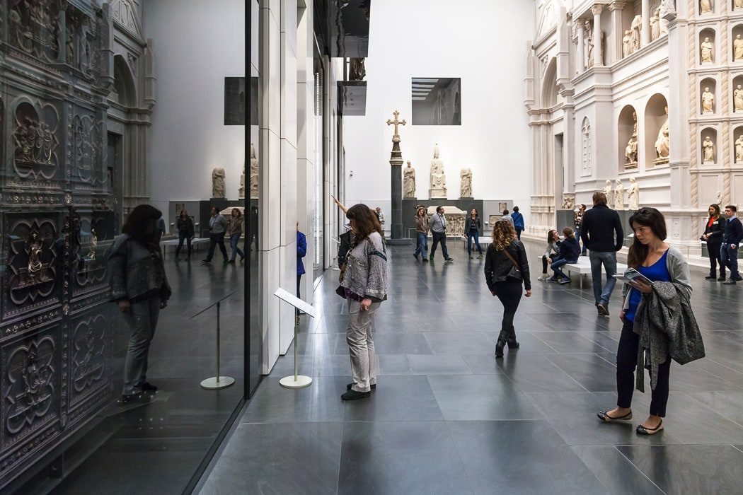Moderner Museumssaal mit Statuen und großen Türen als Exponate